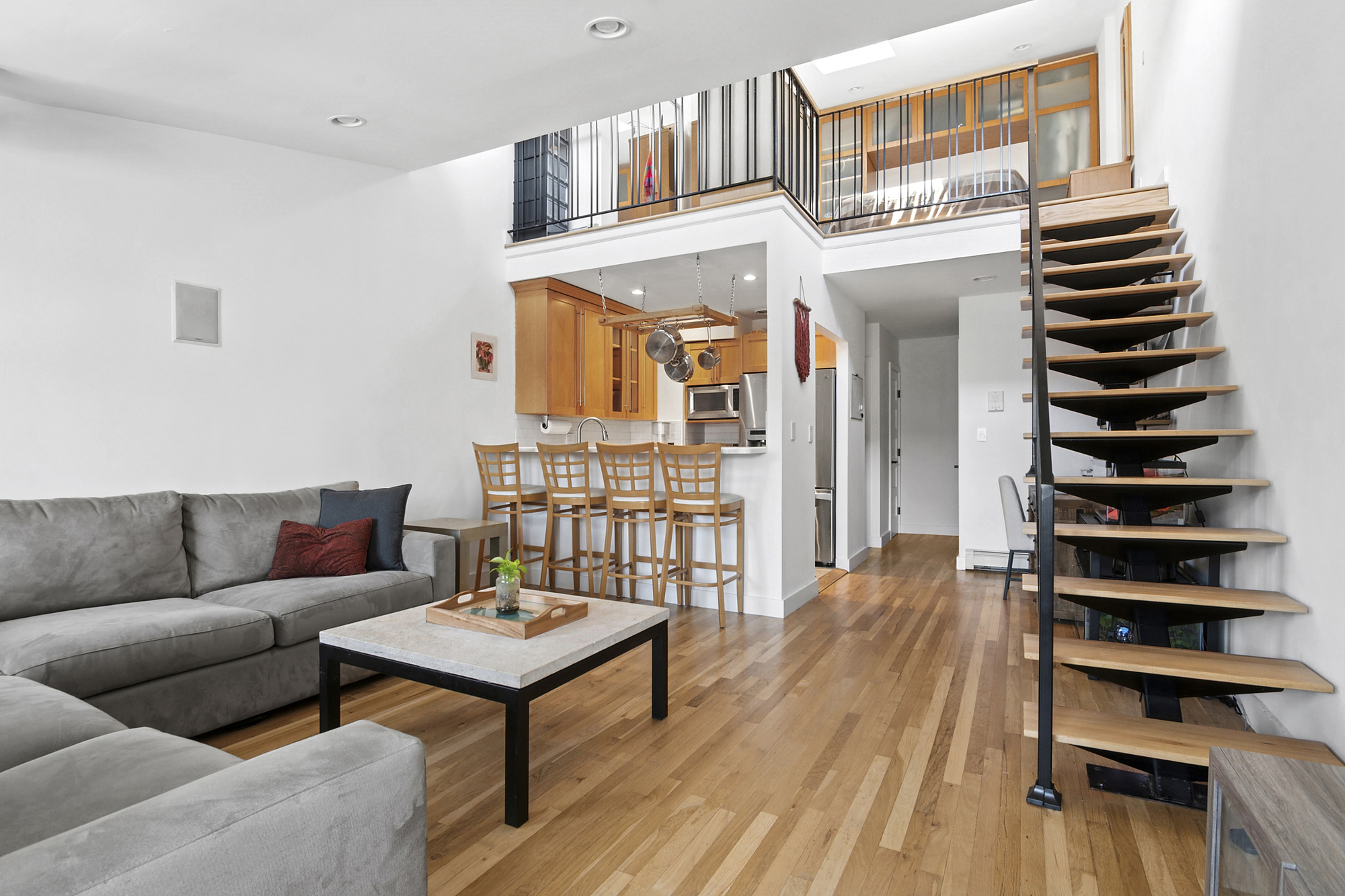 a living room with furniture a rug and a wooden floor