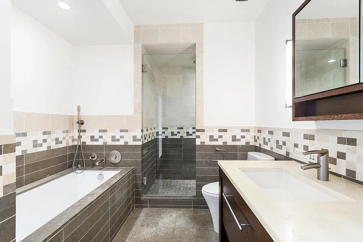 101 West 24th Street, Unit 26D Manhattan, NY 10011 - Photo 5 of 18 a large white kitchen with a large window