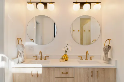 a bathroom with a double vanity sink and a mirror