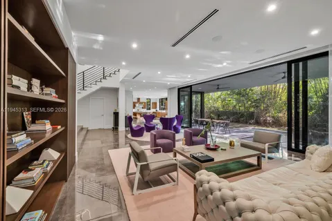 a living room with lots of furniture and a large window