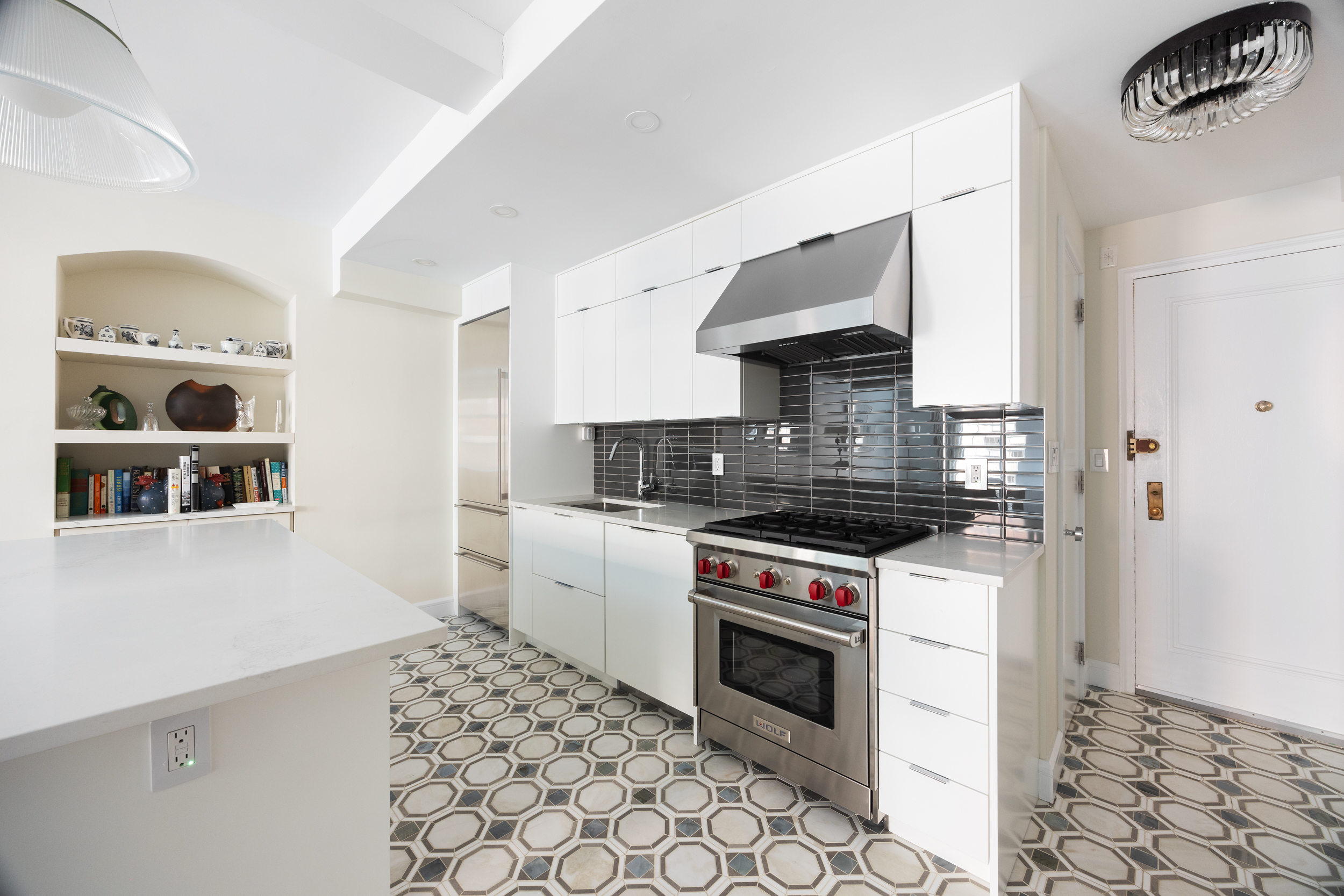 470 West 24th Street, Unit 9J Manhattan, NY 10011 - Photo 5 of 13 a kitchen with a stove and a refrigerator