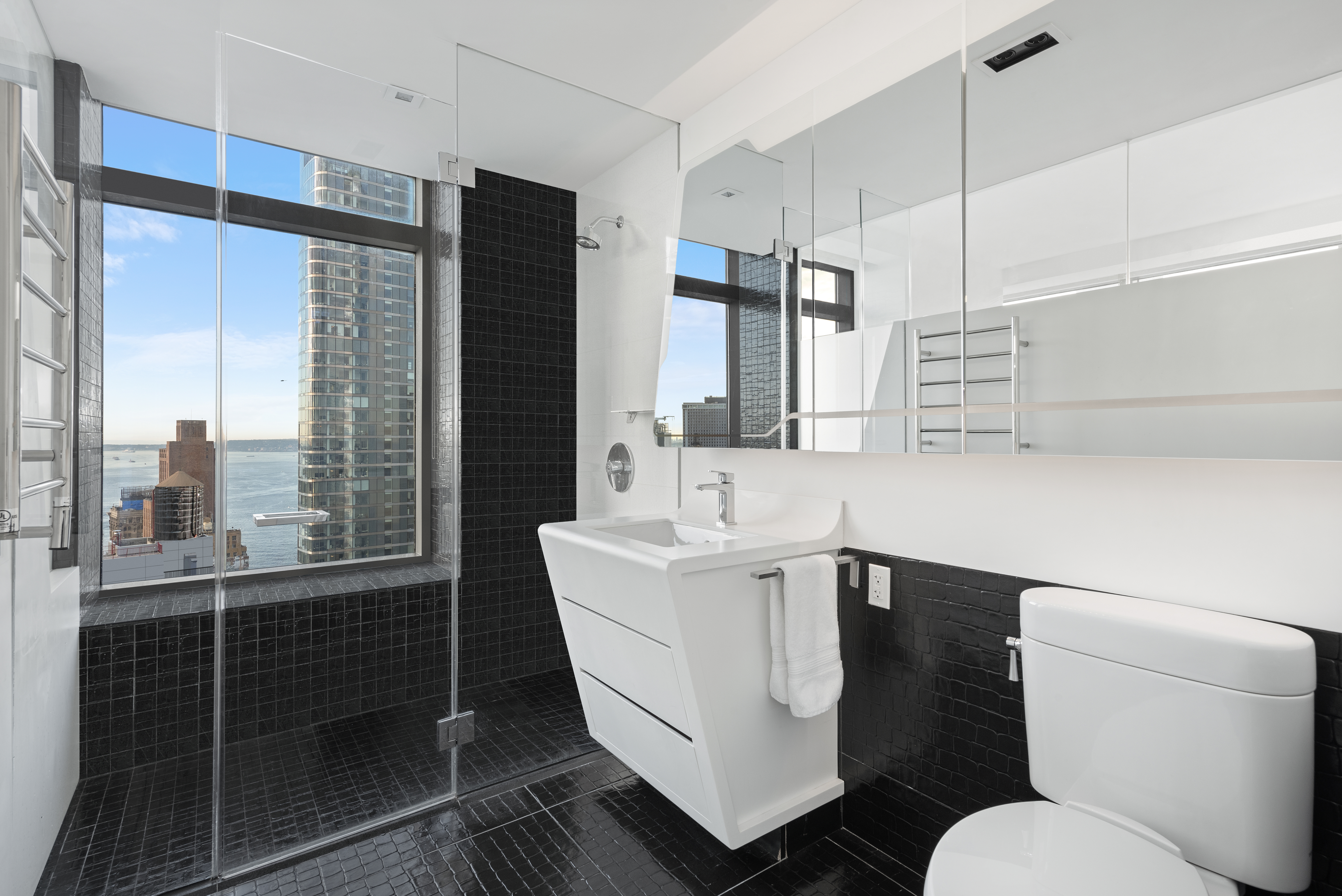 123 Washington Street, Unit 49G Manhattan, NY 10006 - Photo 4 of 11 a bathroom with a sink toilet and shower