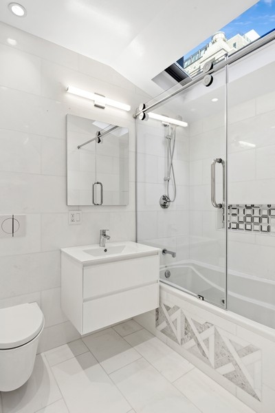 128 West 70th Street, Unit 10 Manhattan, NY 10023 - Photo 5 of 15 a bathroom with a sink toilet and shower