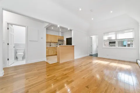 a view of a kitchen with a sink and cabinets