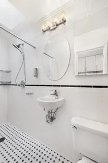 a bathroom with a sink a toilet and a mirror