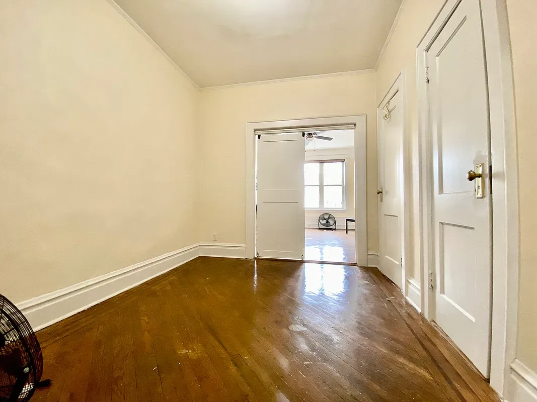 a view of an empty room and glass door