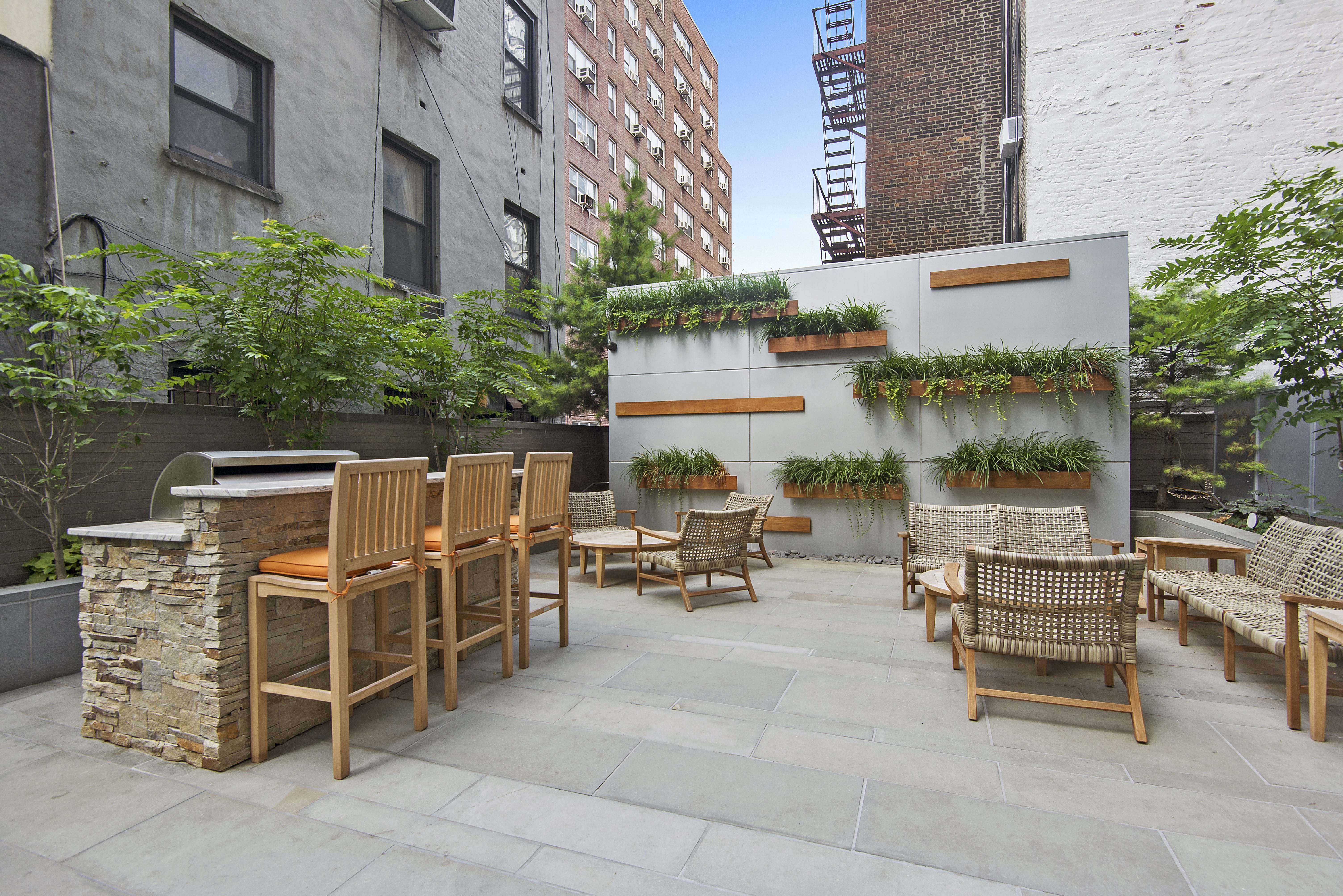 225 East 34th Street, Unit 14J Manhattan, NY 10016 - Photo 10 of 19 a view of a patio with table and chairs and potted plants
