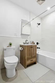 a bathroom with a toilet a sink and bathtub