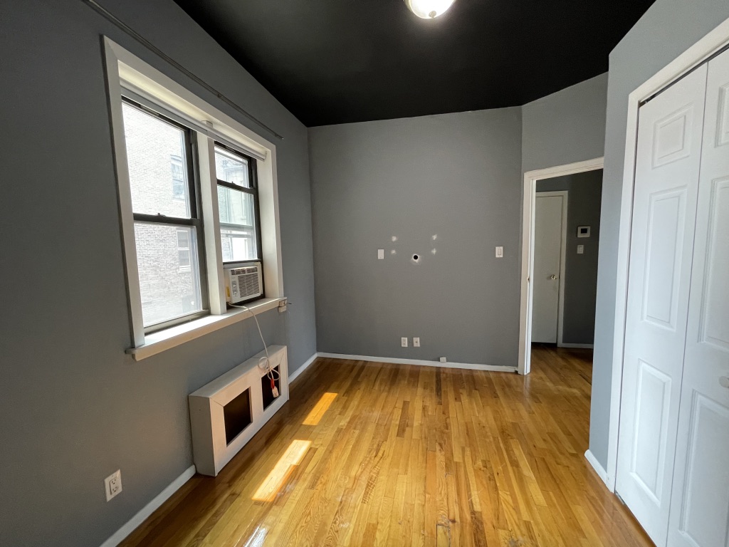 266 West 22nd Street, Unit 2 Manhattan, NY 10011 - Photo 8 of 14 a view of a room with wooden floor and a window