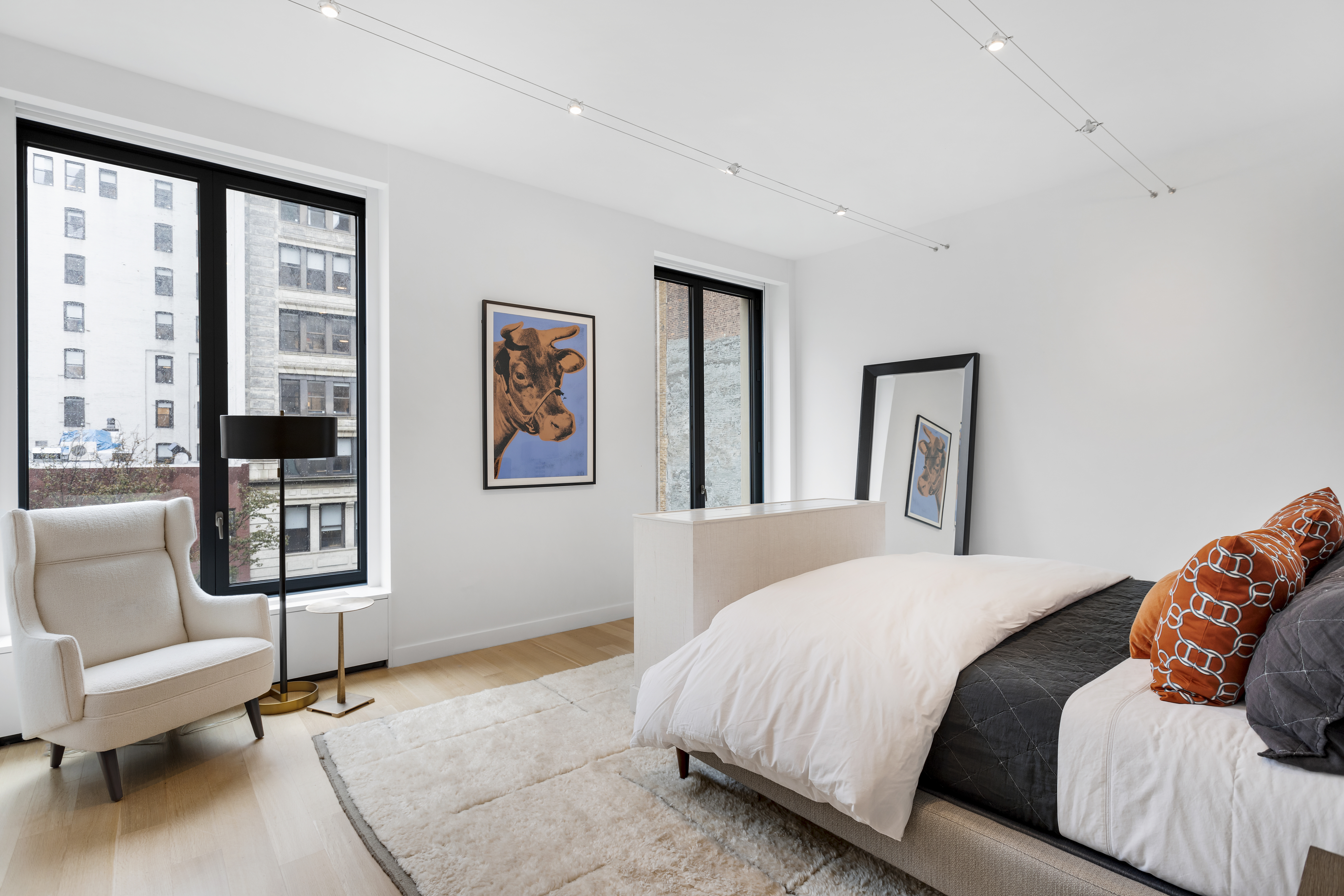 21 East 12th Street, Unit 5B Manhattan, NY 10003 - Photo 6 of 11 a bedroom with a bed couch and a large window