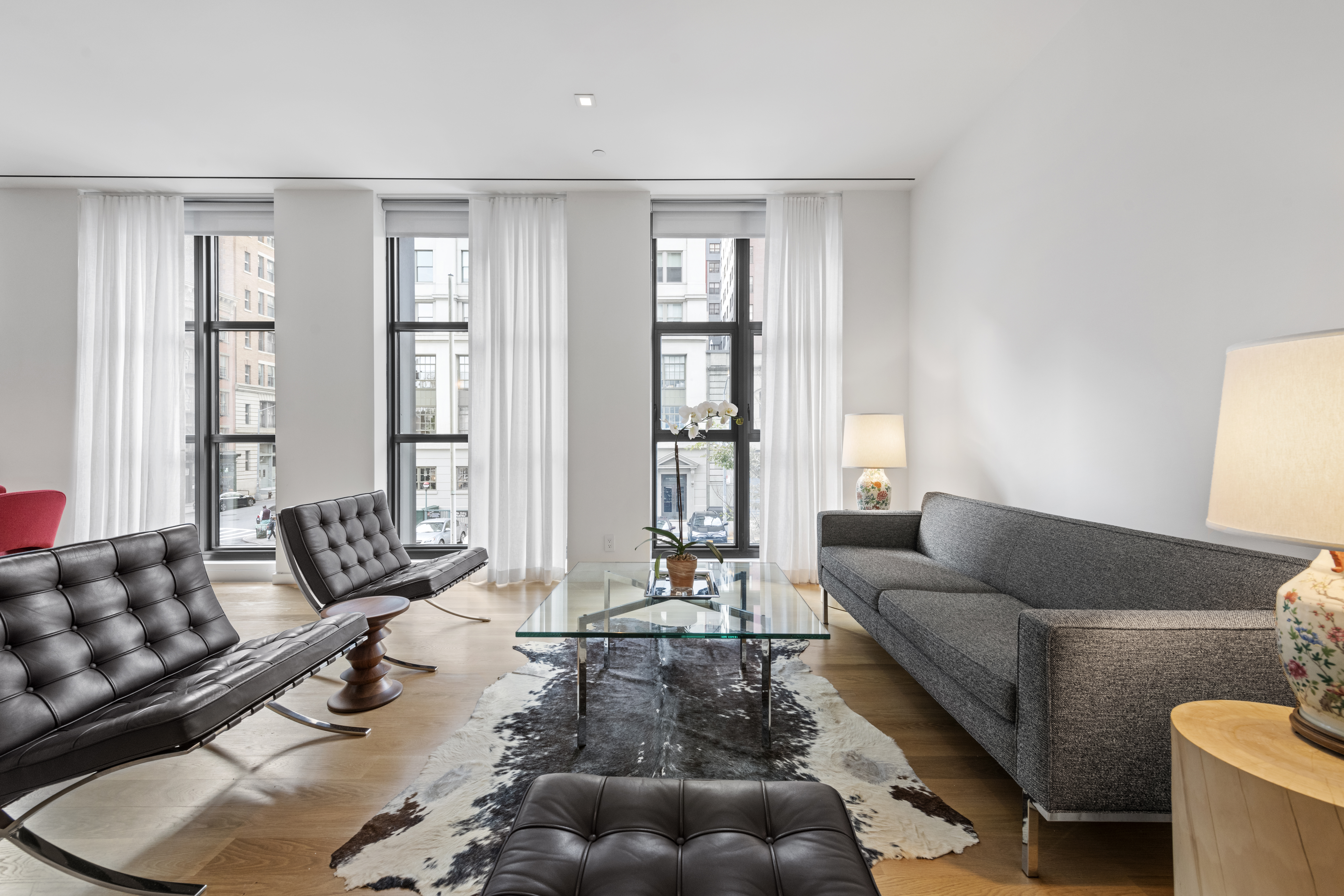 11 North Moore Street, Unit 2B Manhattan, NY 10013 - Photo 2 of 12 a living room with furniture and floor to ceiling windows