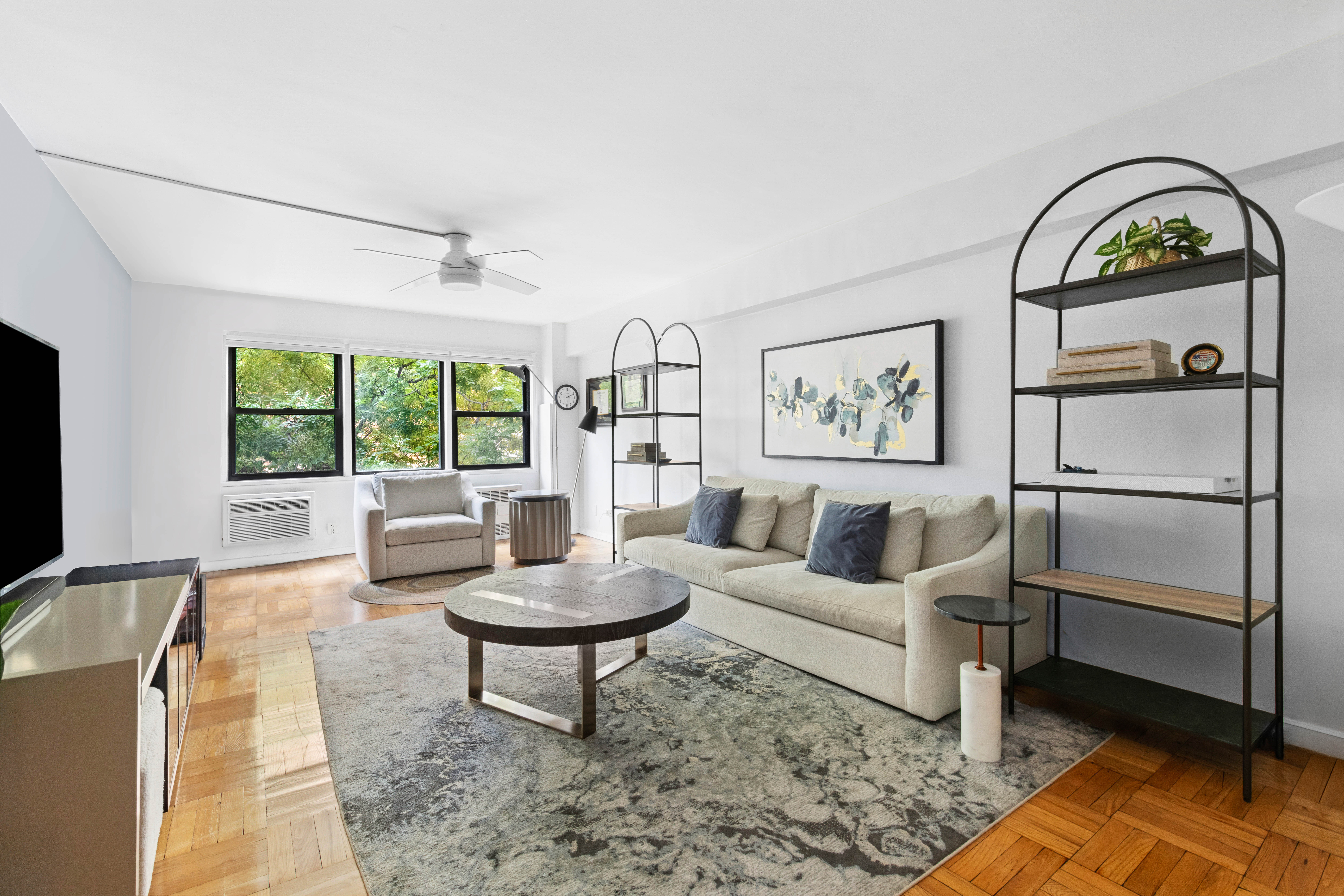 205 East 77th Street, Unit 4B Manhattan, NY 10075 - Photo 2 of 10 a living room with furniture a window and a table