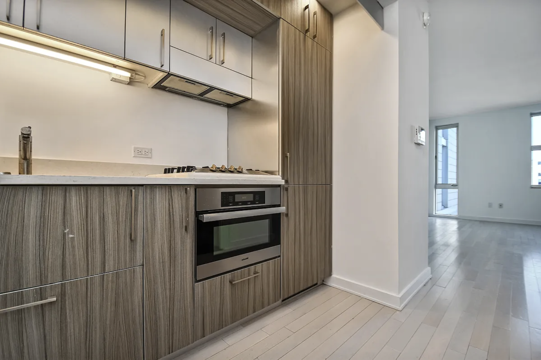 250 Bedford Avenue, Unit 308 Brooklyn, NY 11249 - Photo 3 of 8 a kitchen with stainless steel appliances a stove and a refrigerator