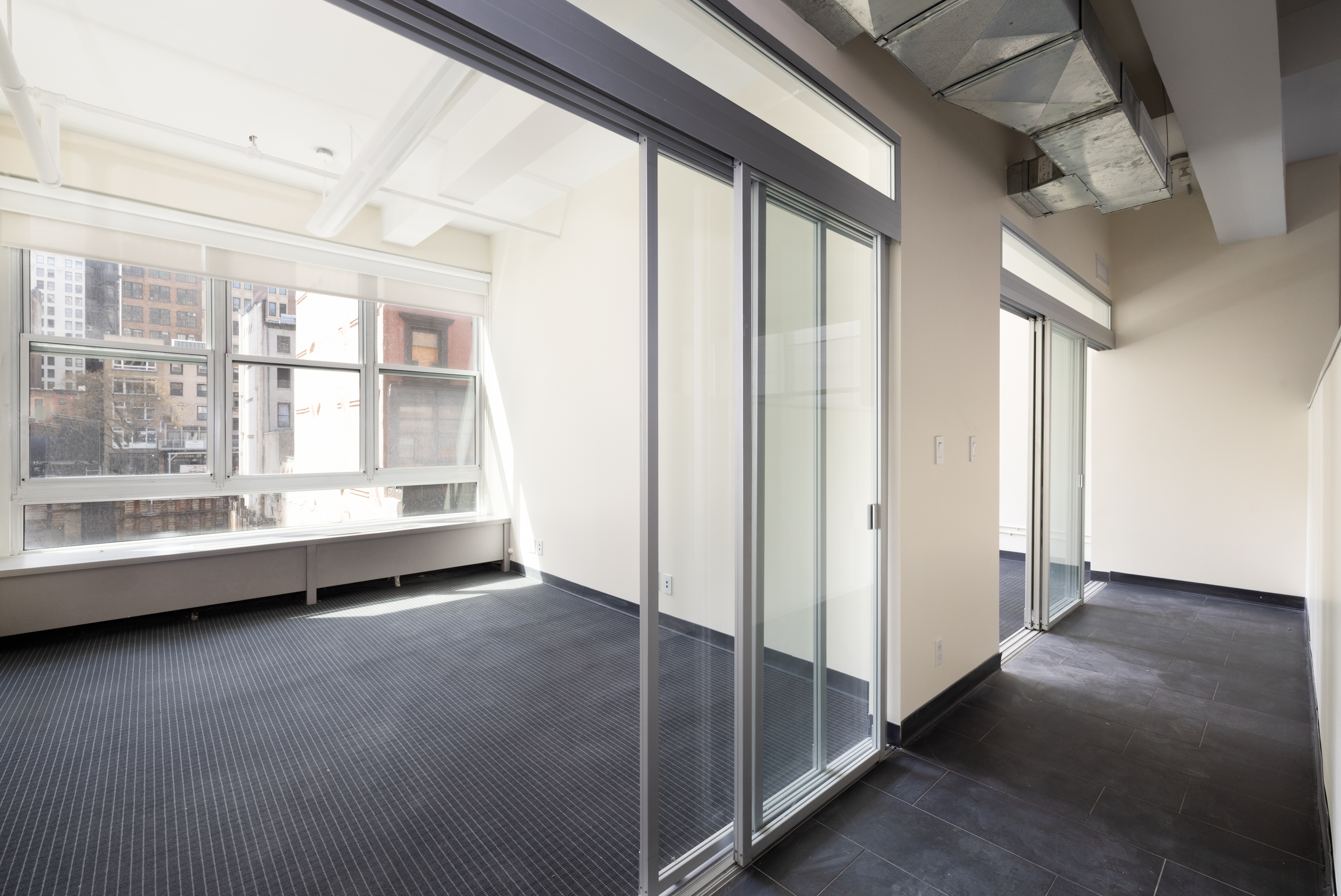 11 West 30th Street, Unit 2F Manhattan, NY 10001 - Photo 6 of 12 a view of an empty room with a window