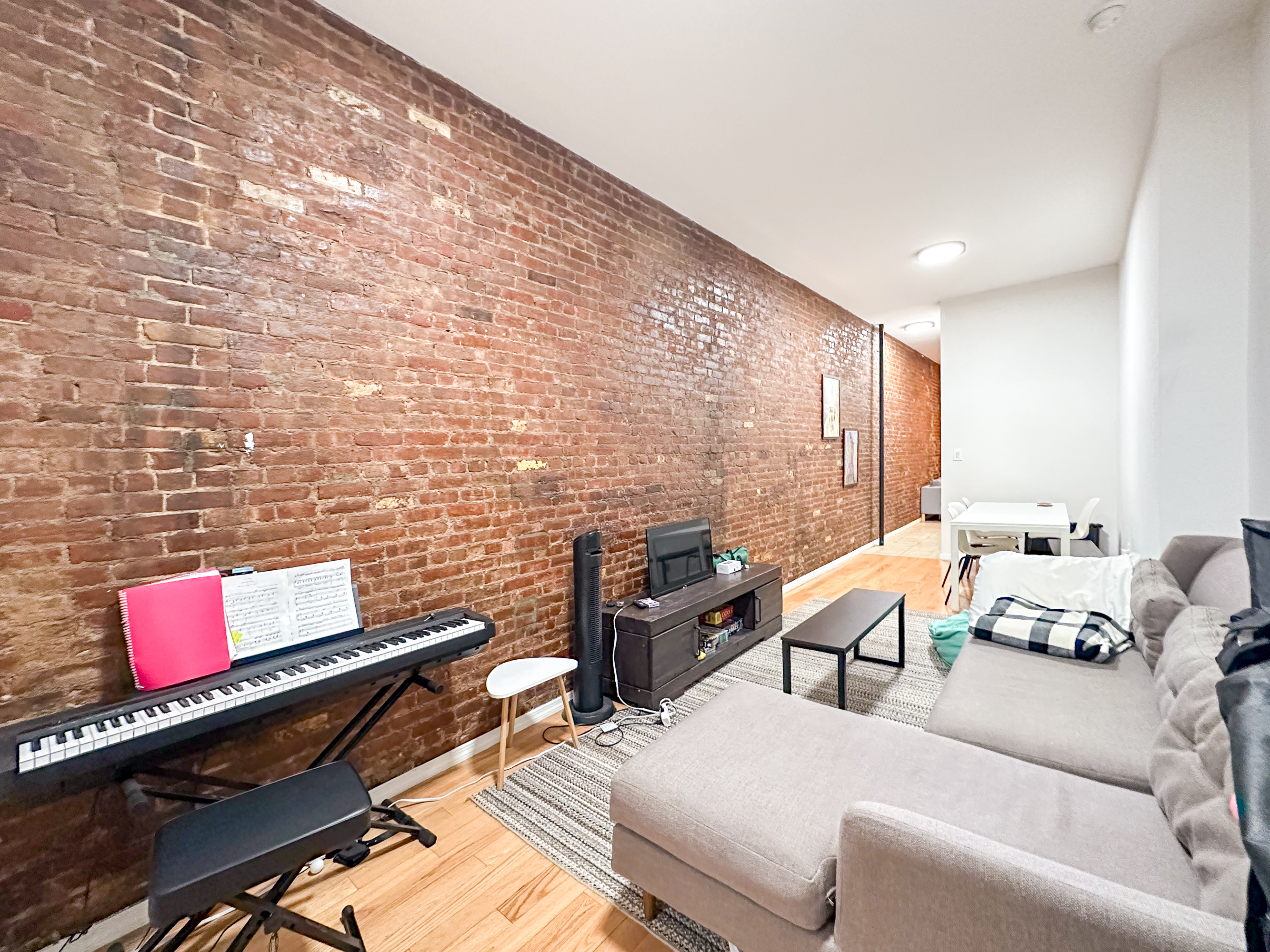 213 East 5th Street, Unit 1 Manhattan, NY 10003 - Photo 6 of 18 a living room with furniture