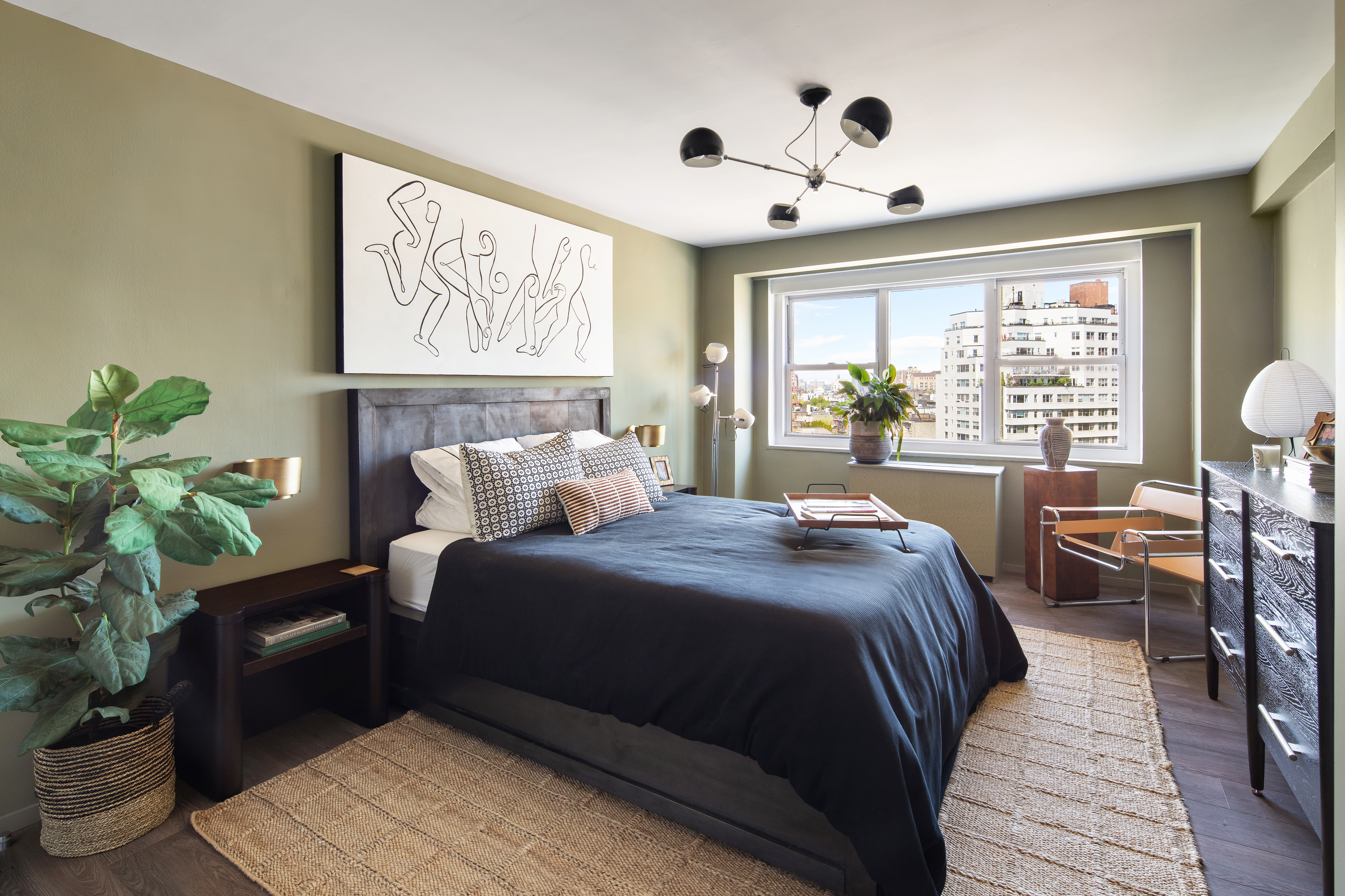 69 West 9th Street, Unit 11CDE Manhattan, NY 10011 - Photo 7 of 9 a bedroom with a bed and wooden floor