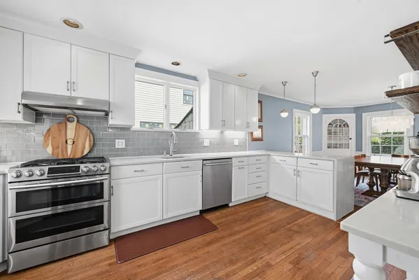 a kitchen with sink a stove and cabinets