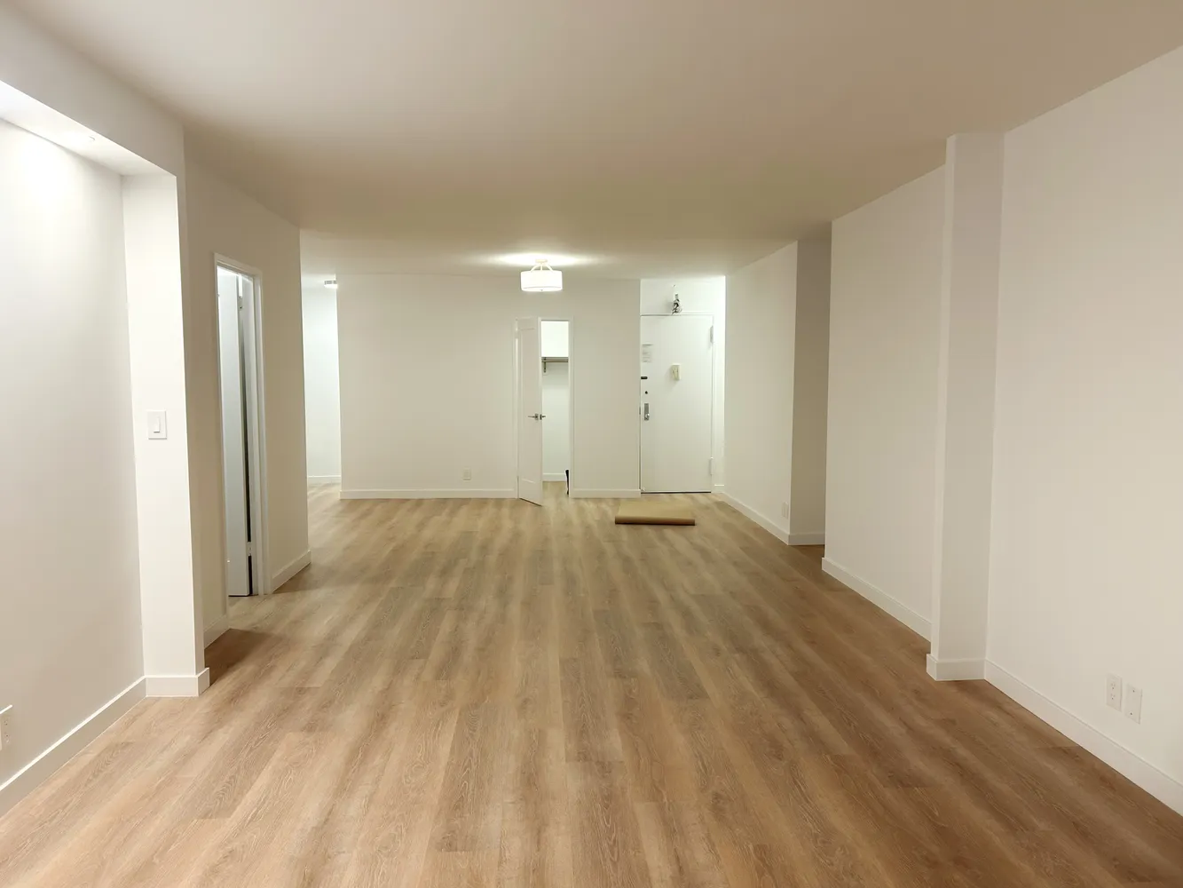 a bedroom with a bed a mirror and window