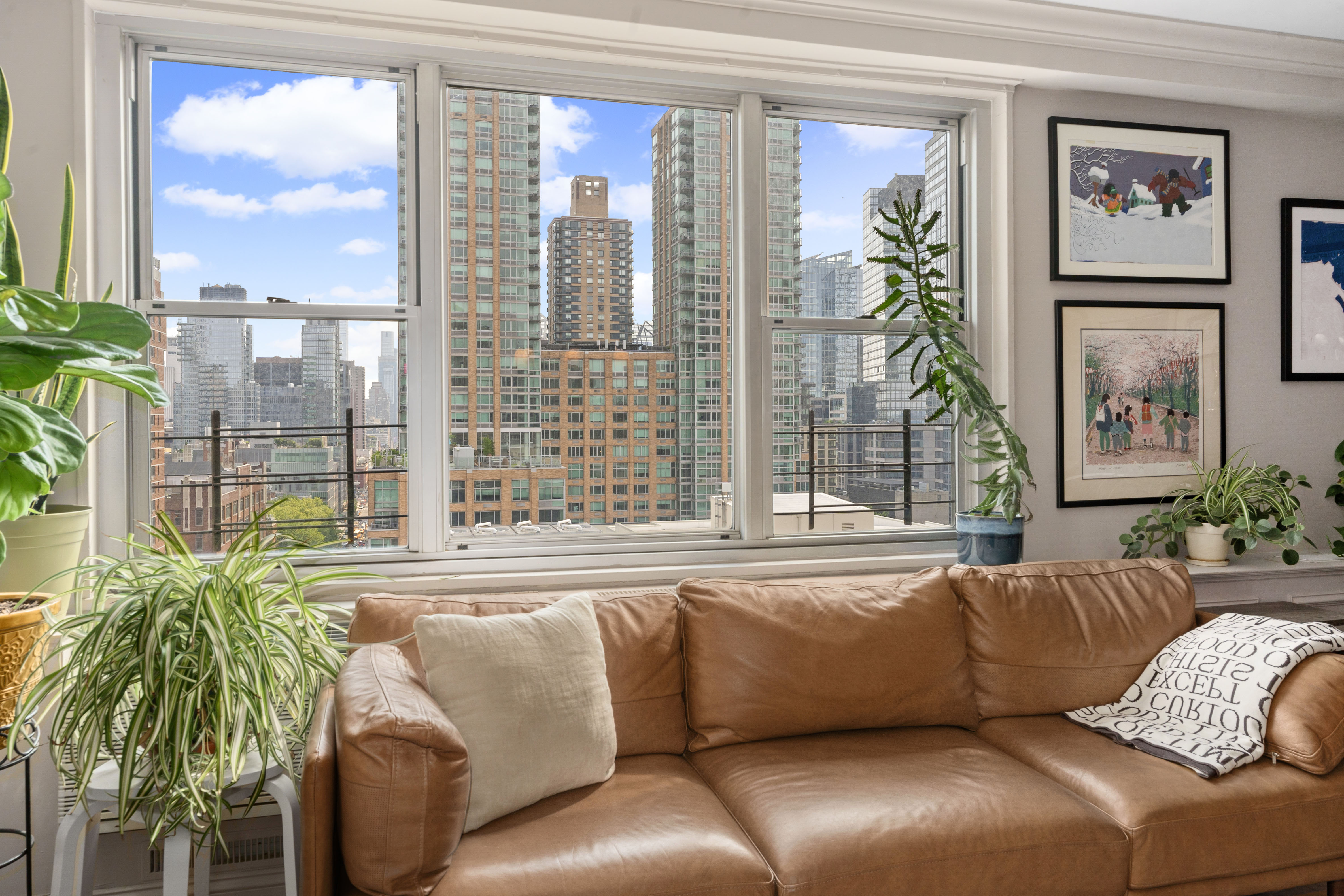303 West 66th Street, Unit 18EE Manhattan, NY 10023 - Photo 3 of 24 a living room with furniture and a large window