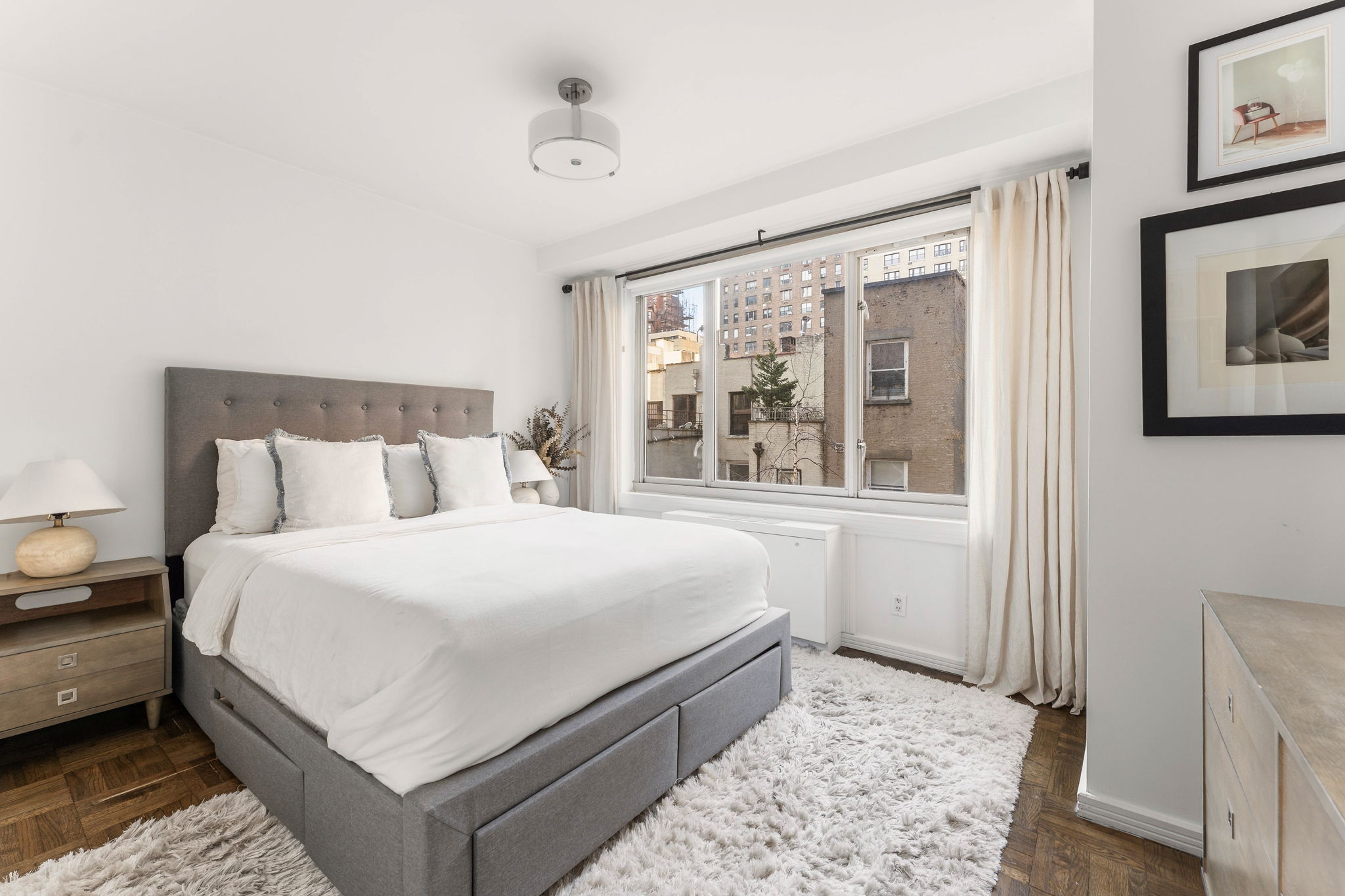315 West 70th Street, Unit 5F Manhattan, NY 10023 - Photo 5 of 9 a bedroom with a large bed and a window