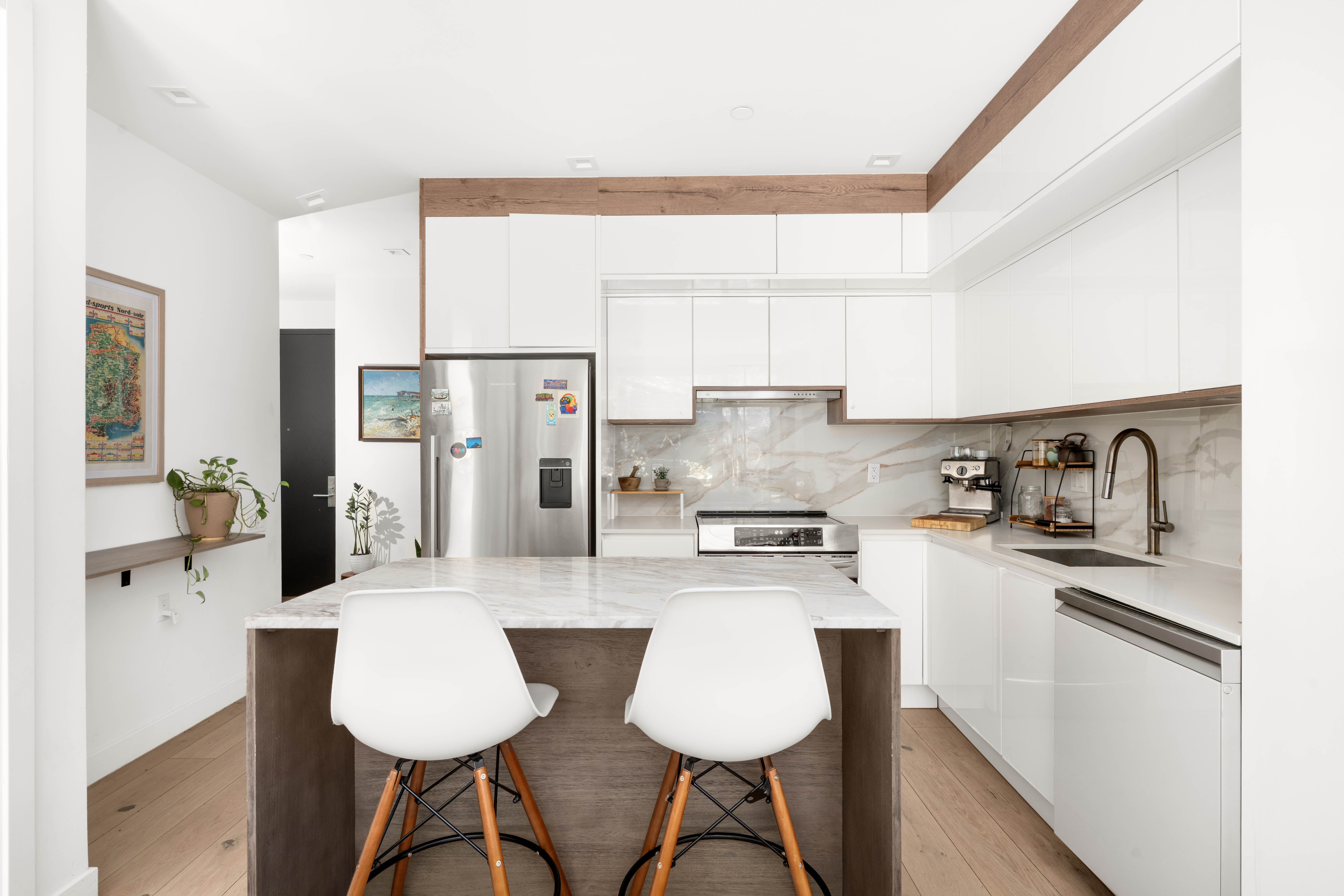 676 Halsey Street, Unit 1B Brooklyn, NY 11233 - Photo 4 of 9 a kitchen with stainless steel appliances kitchen island granite countertop a refrigerator a sink a stove a dining table and chairs with wooden floor