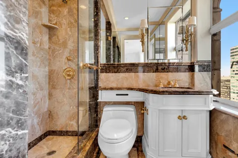 a bathroom with a sink toilet and shower
