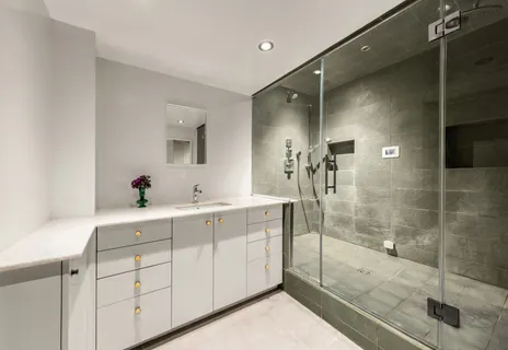 a bathroom with a shower sink and mirror