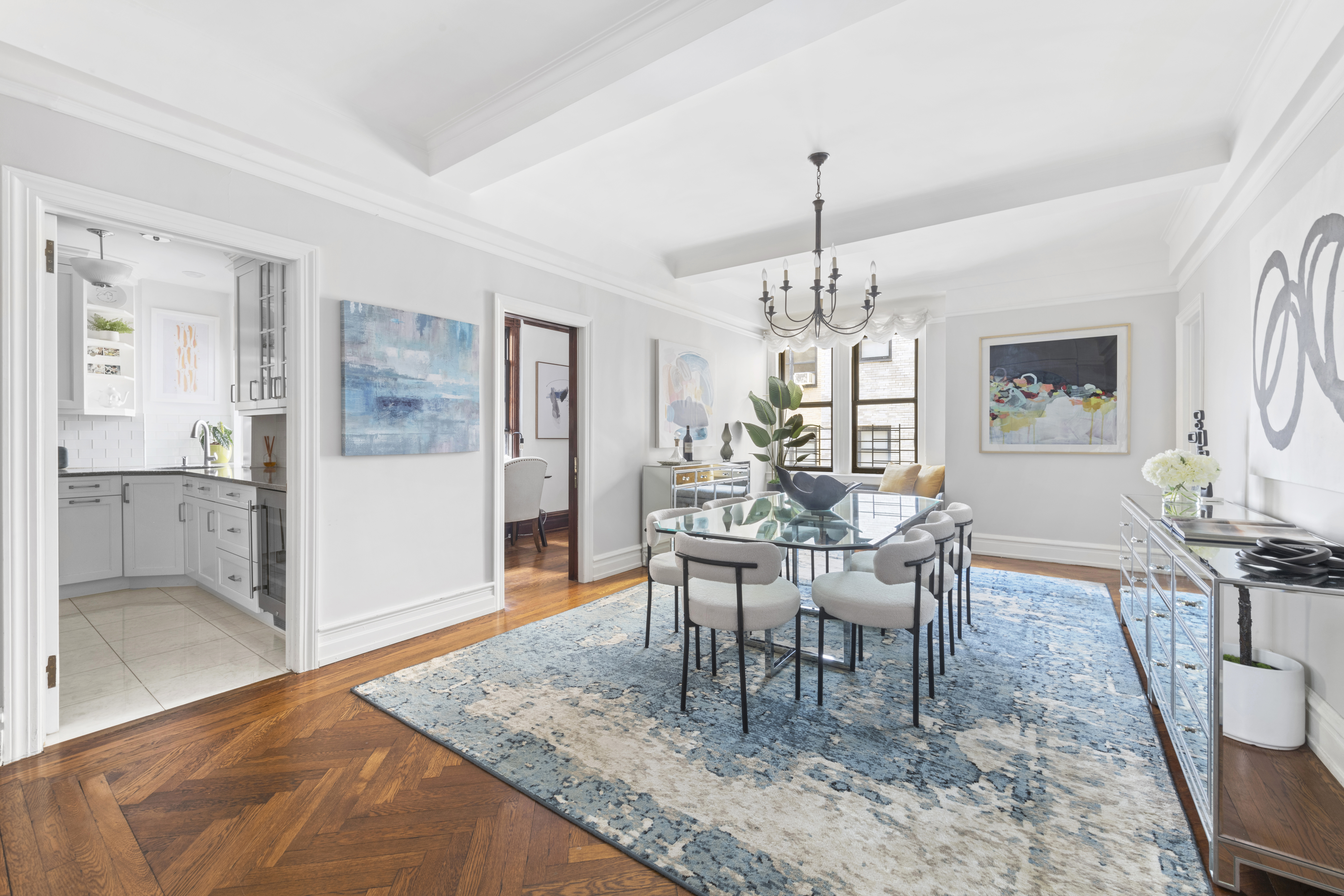 410 East 57th Street, Unit 15BE Manhattan, NY 10022 - Photo 3 of 18 a dining room with chandelier and wooden floor