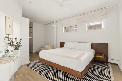 a bedroom with a bed and a couch