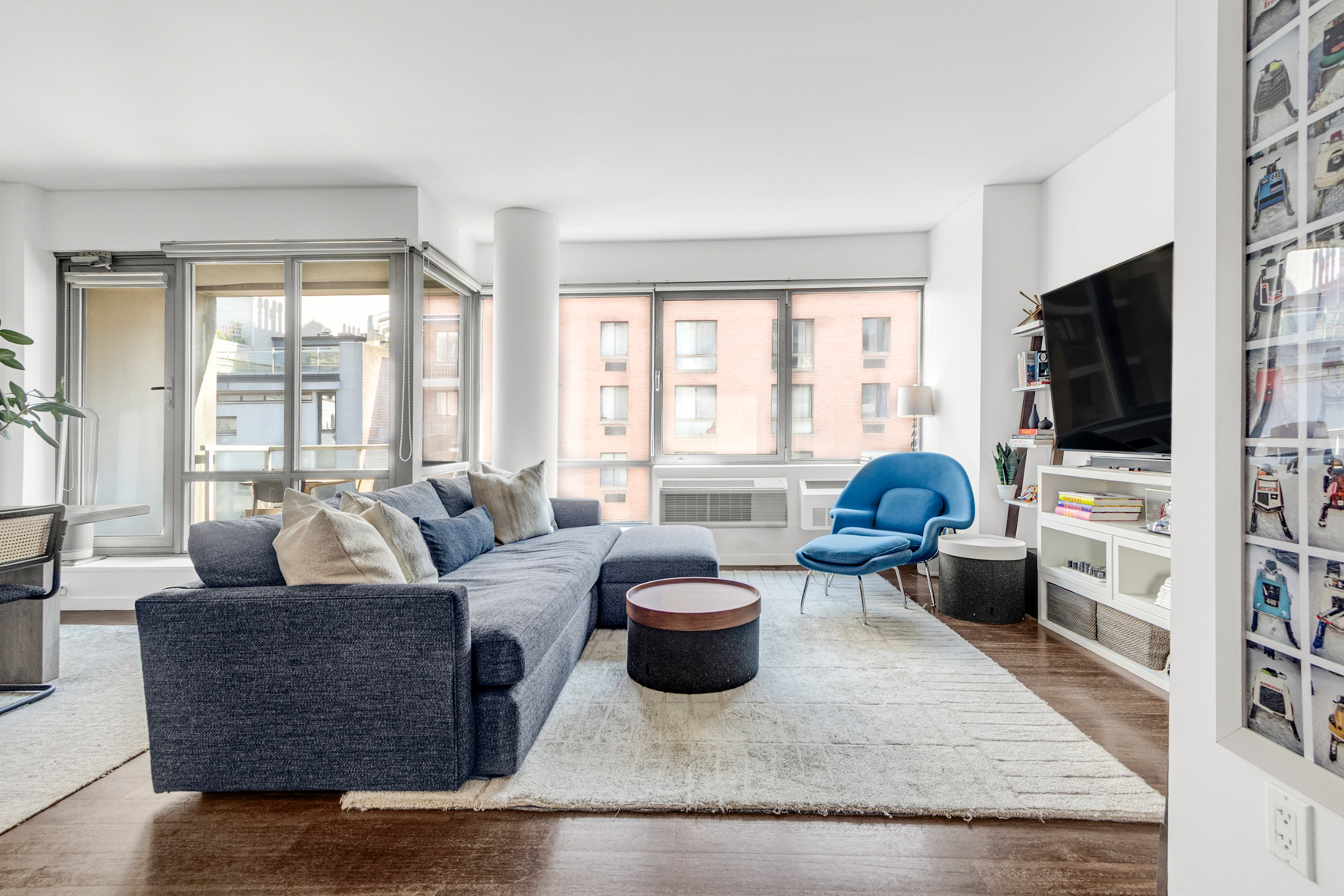444 West 19th Street, Unit 701 Manhattan, NY 10011 - Photo 1 of 11 a living room with furniture and a flat screen tv