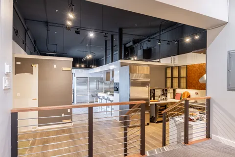 a kitchen with stainless steel appliances kitchen island granite countertop a sink and cabinets