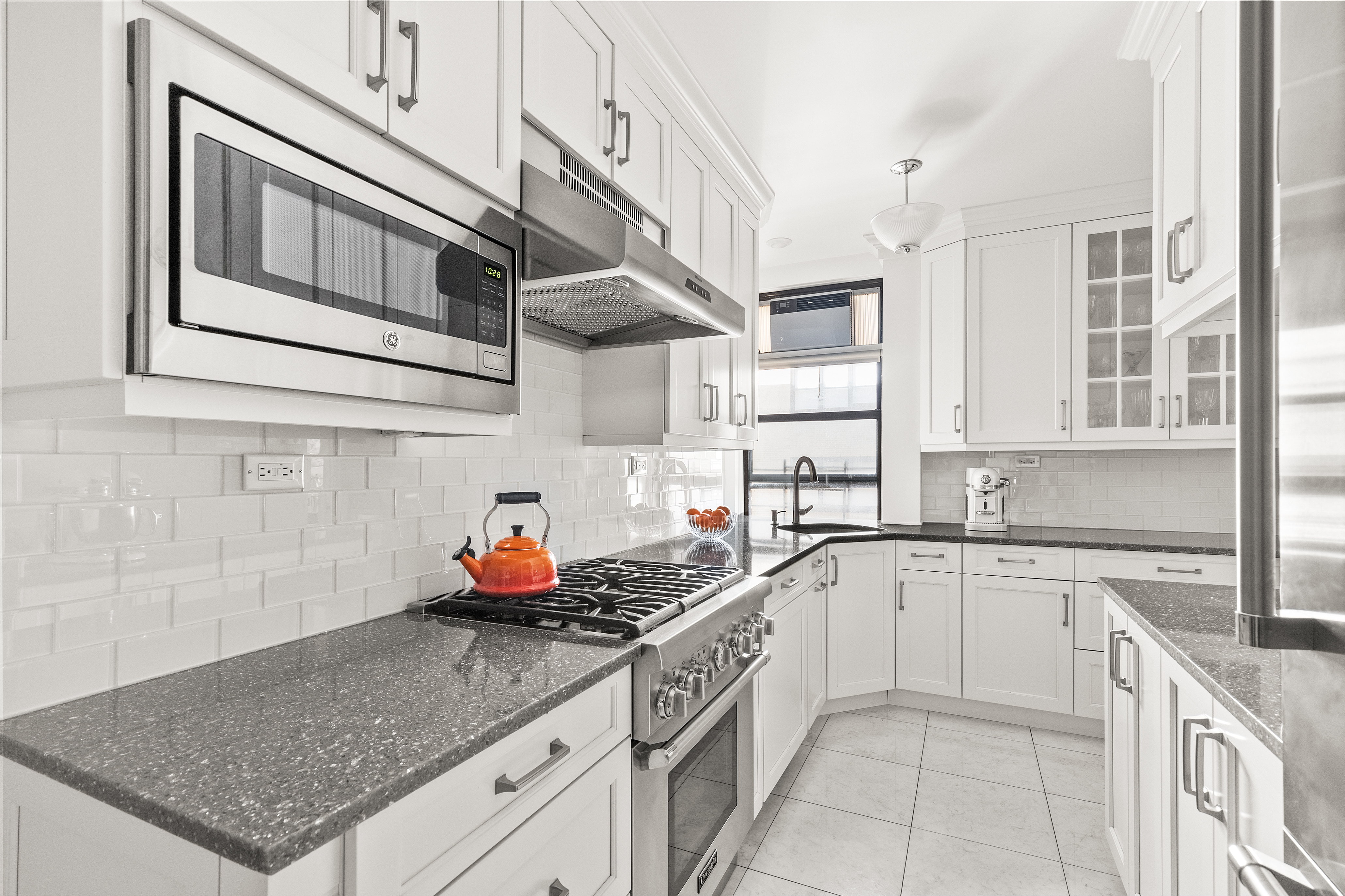 410 East 57th Street, Unit 15B Manhattan, NY 10022 - Photo 5 of 17 a kitchen with stainless steel appliances granite countertop a sink stove and cabinets
