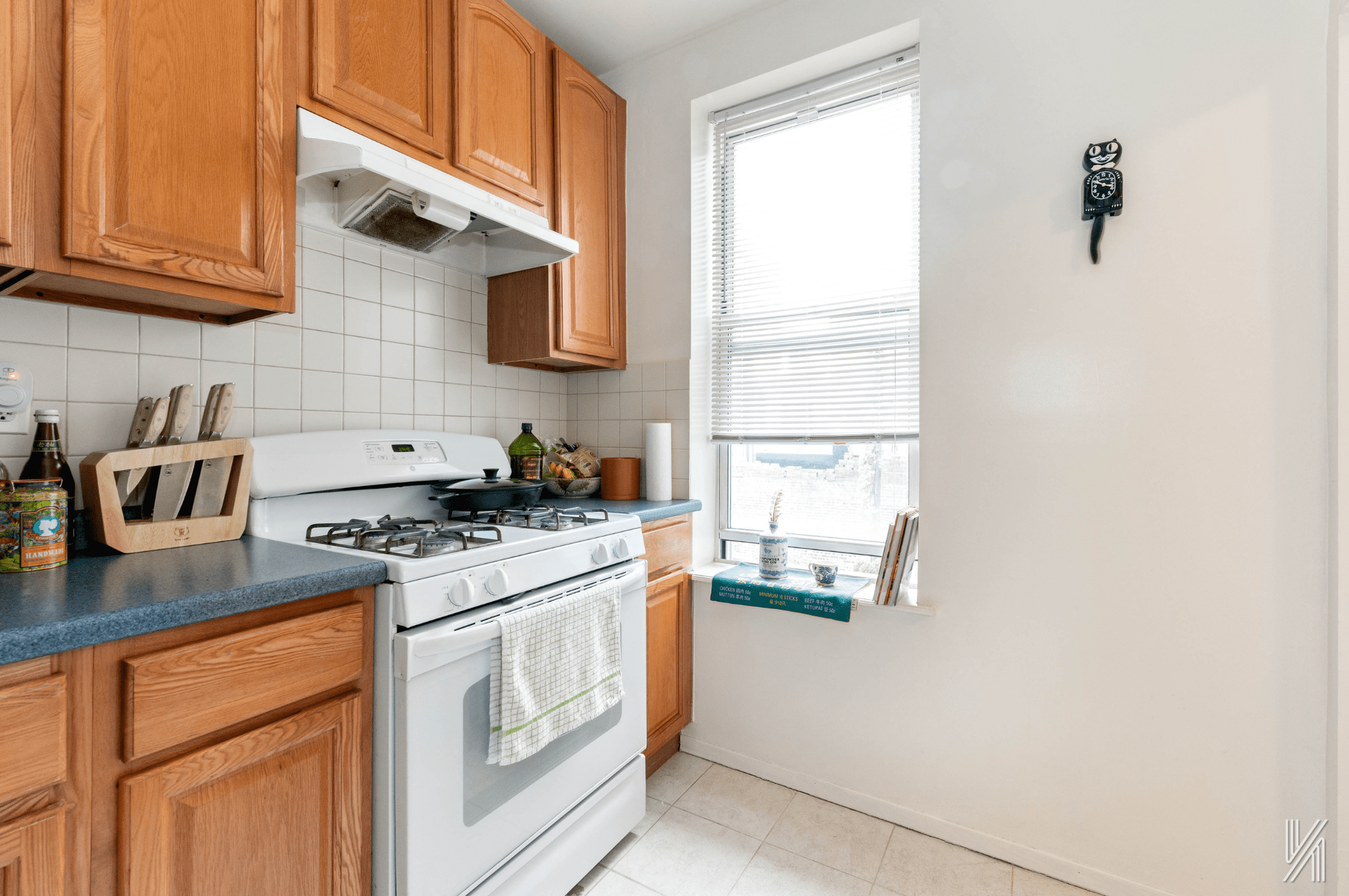 32-10 35th Street Queens, NY 11106 - Photo 20 of 29 a kitchen with stainless steel appliances granite countertop a stove a sink and a microwave