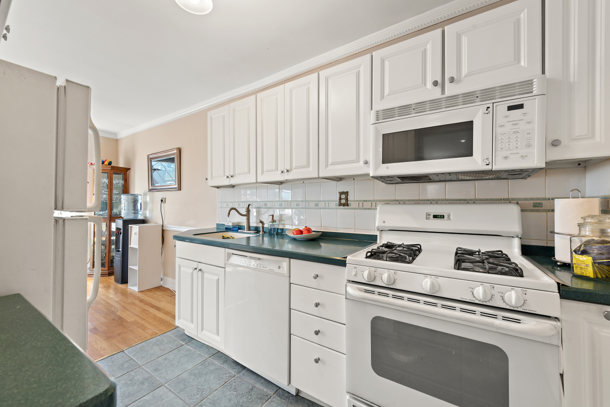 5730 Mosholu Avenue, Unit 4F Bronx, NY 10471 - Photo 10 of 15 a kitchen with cabinets stainless steel appliances and a counter space