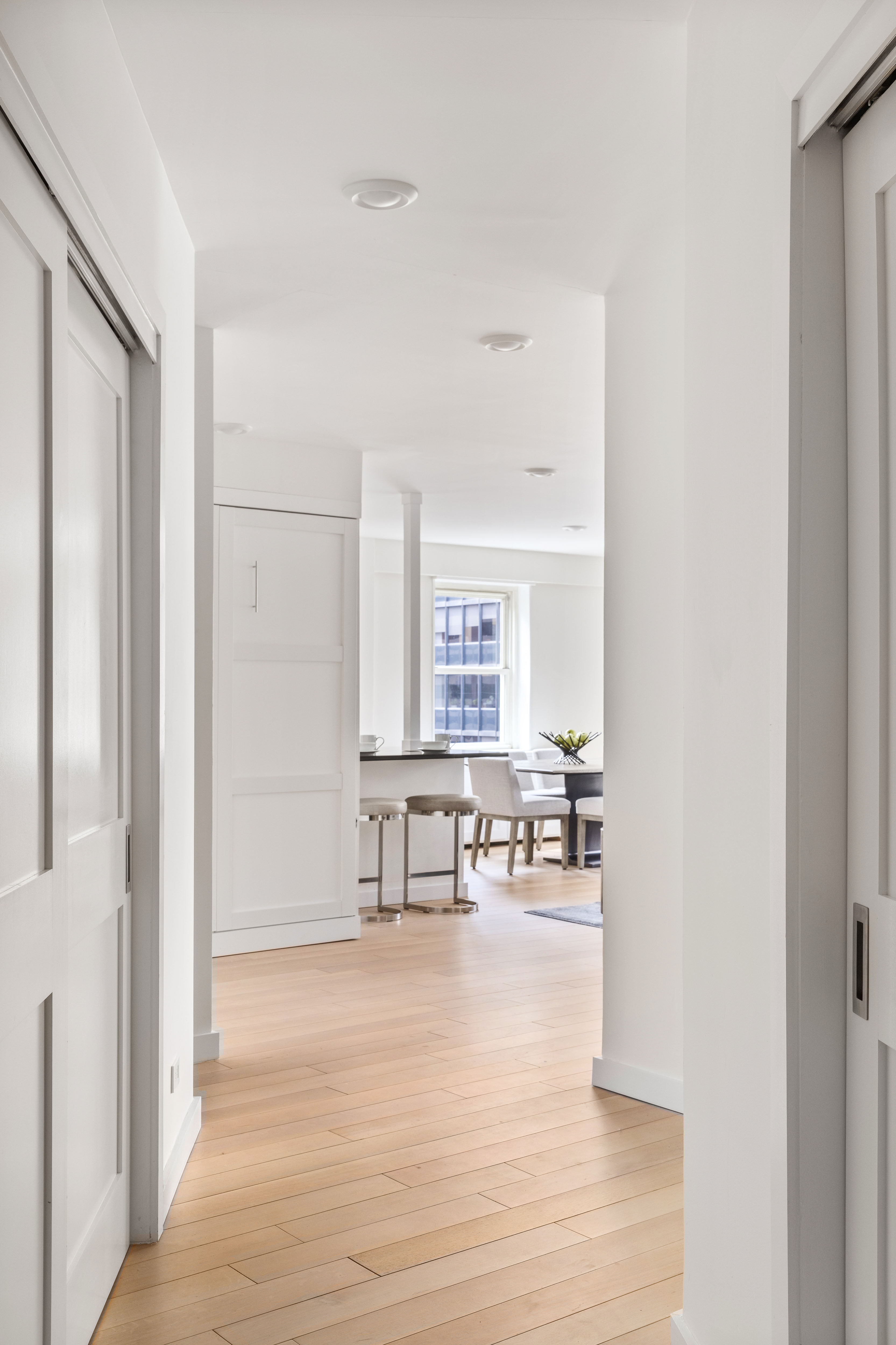 159 West 53rd Street, Unit 34E Manhattan, NY 10019 - Photo 12 of 15 a living room with furniture and a wooden floor