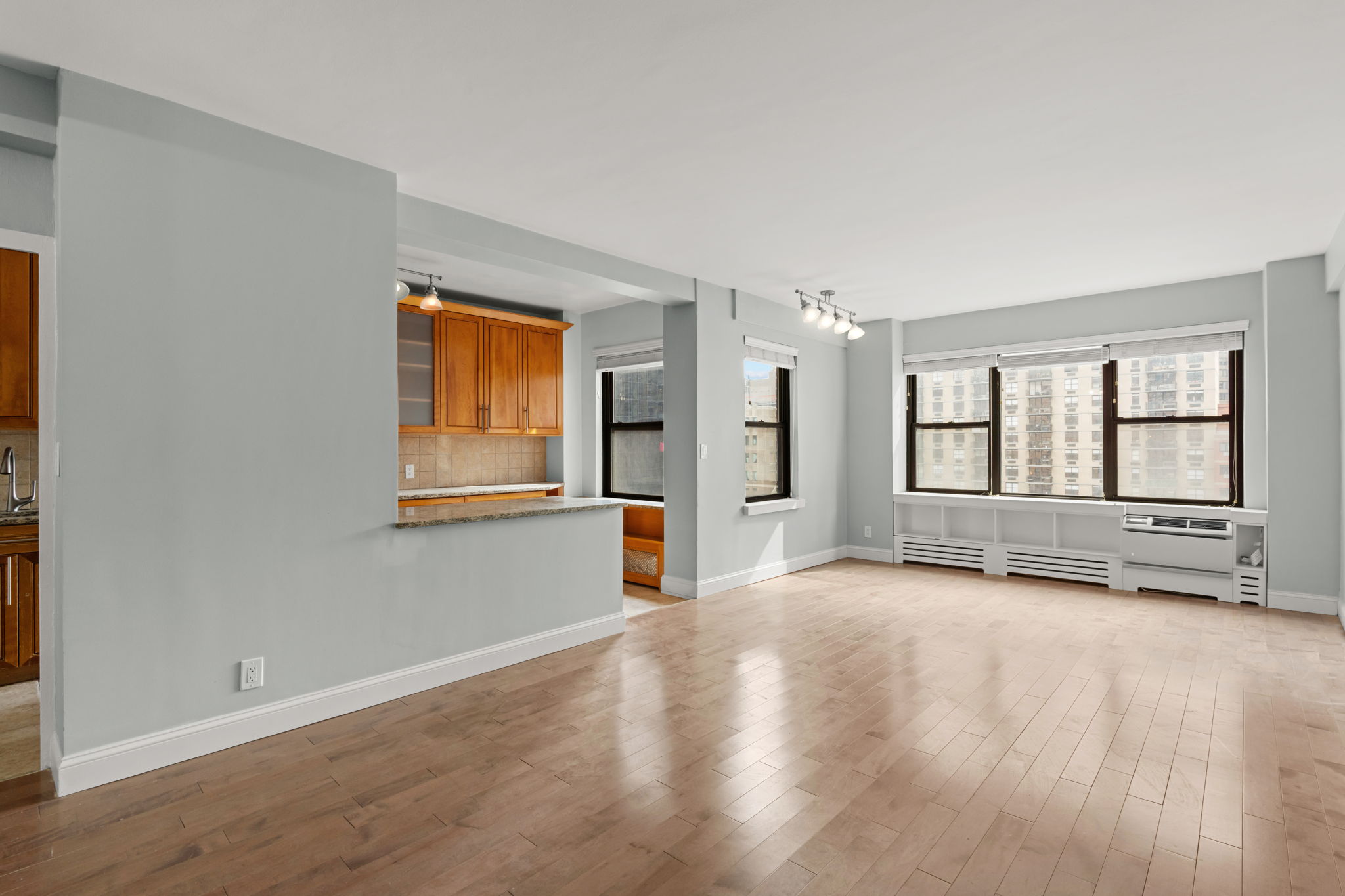 2 Tudor City Place, Unit 6JOS Manhattan, NY 10017 - Photo 3 of 16 an empty room with wooden floor and windows