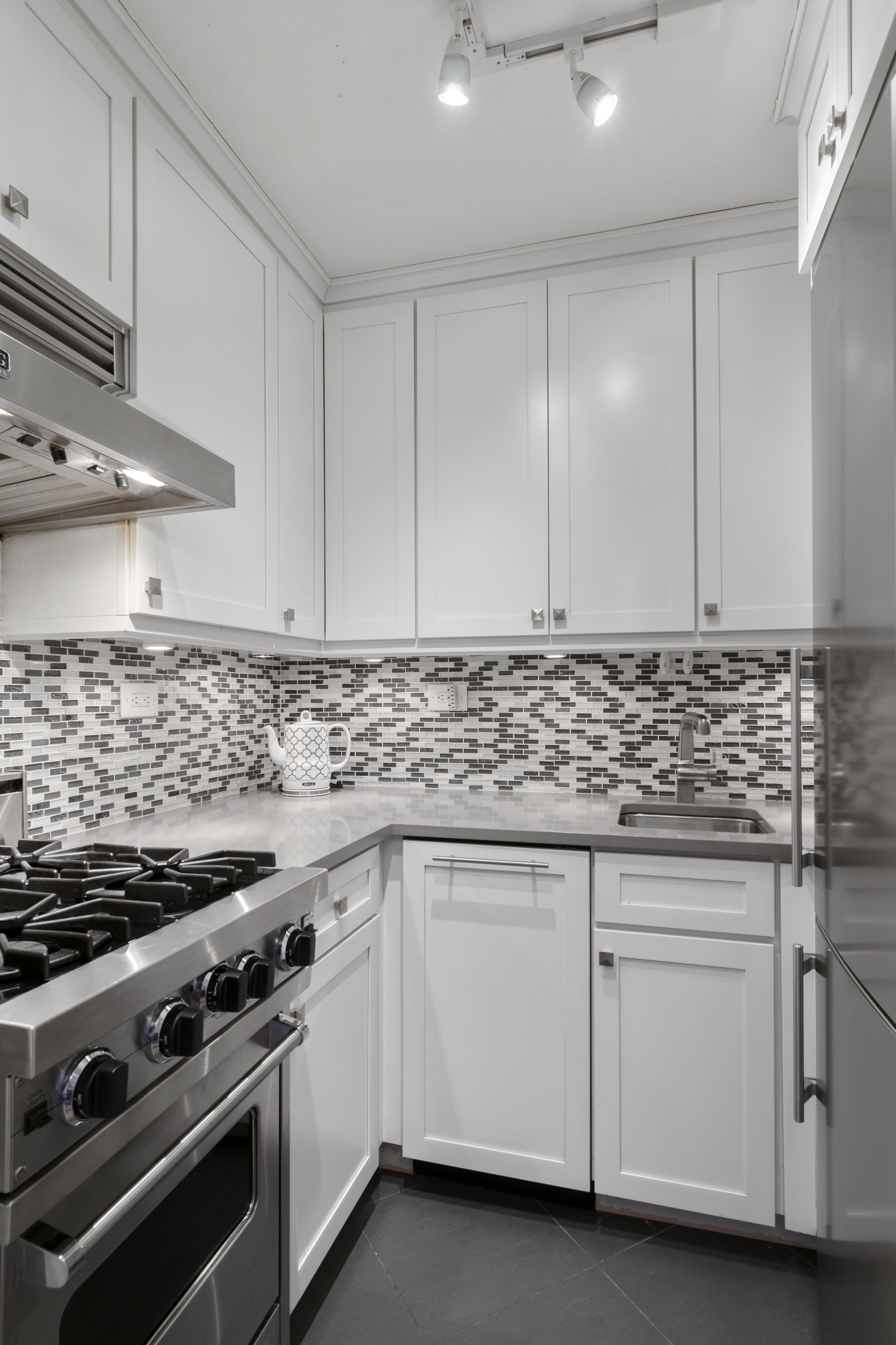 200 East 27th Street, Unit 2V Manhattan, NY 10016 - Photo 3 of 7 a kitchen with granite countertop white cabinets and white appliances