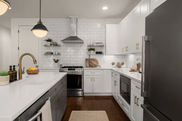 a kitchen with a sink a stove and cabinets