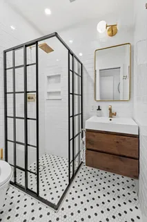 a bathroom with a sink a mirror and shower