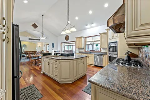 a kitchen with a table chairs refrigerator and cabinets