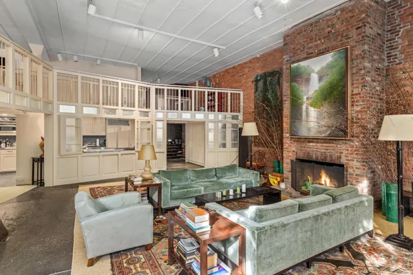 a living room with furniture a fireplace and a flat screen tv