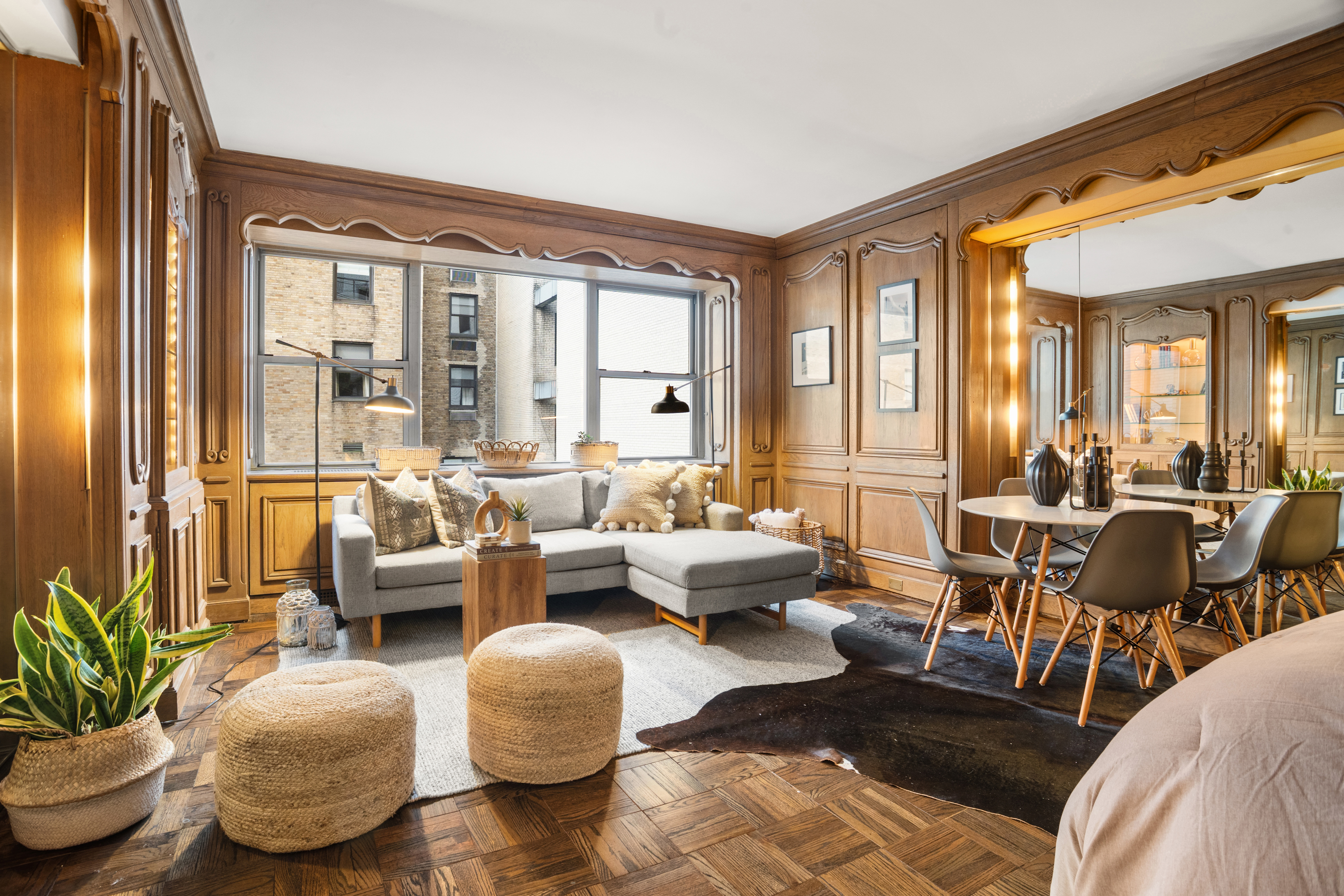 110 East 57th Street, Unit 16B Manhattan, NY 10022 - Photo 3 of 15 a living room with furniture and a large window