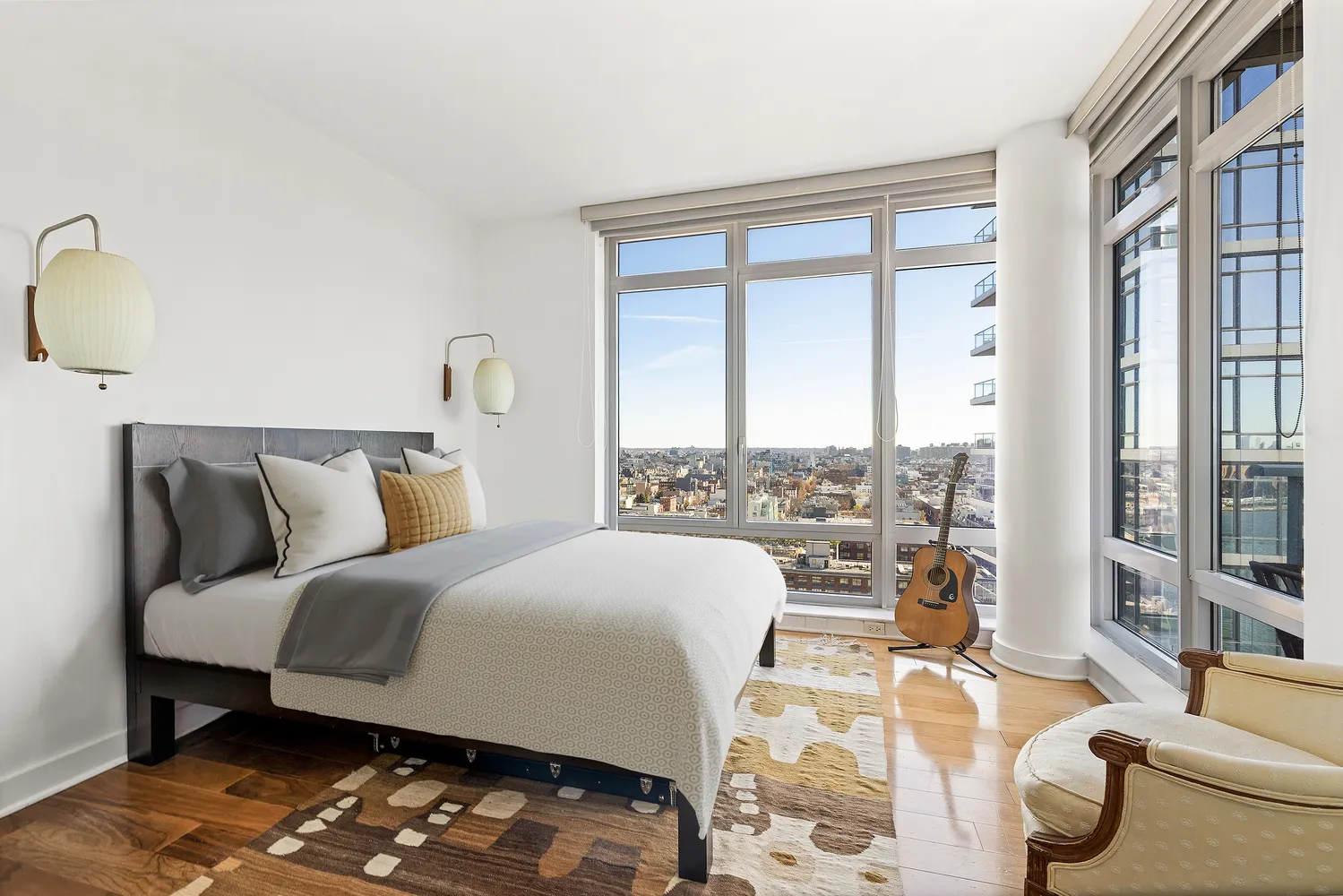 a bedroom with a bed and glass window