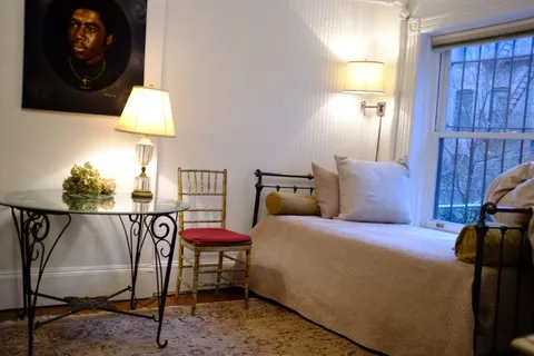 a bedroom with a bed and a lamp on table