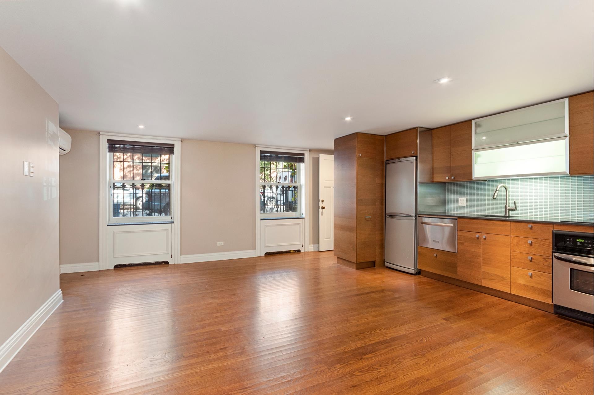 150 Dean Street, Unit 1 Brooklyn, NY 11217 - Photo 3 of 7 a view of an empty room with window and wooden floor