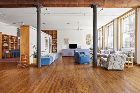 a living room with furniture or couch and a wooden floor