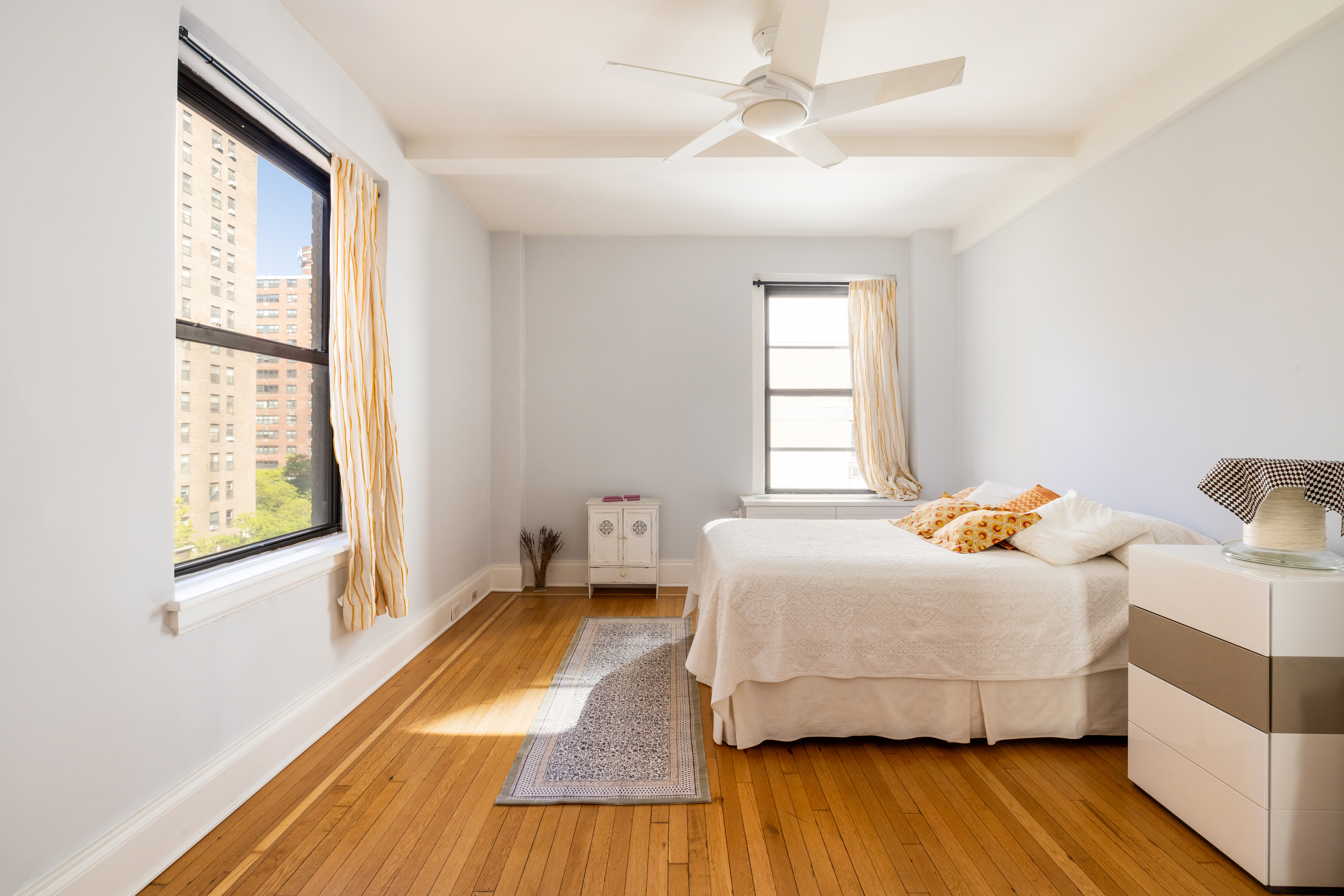 124 West 93rd Street, Unit 6E Manhattan, NY 10025 - Photo 6 of 9 a bedroom with a bed and wooden floor