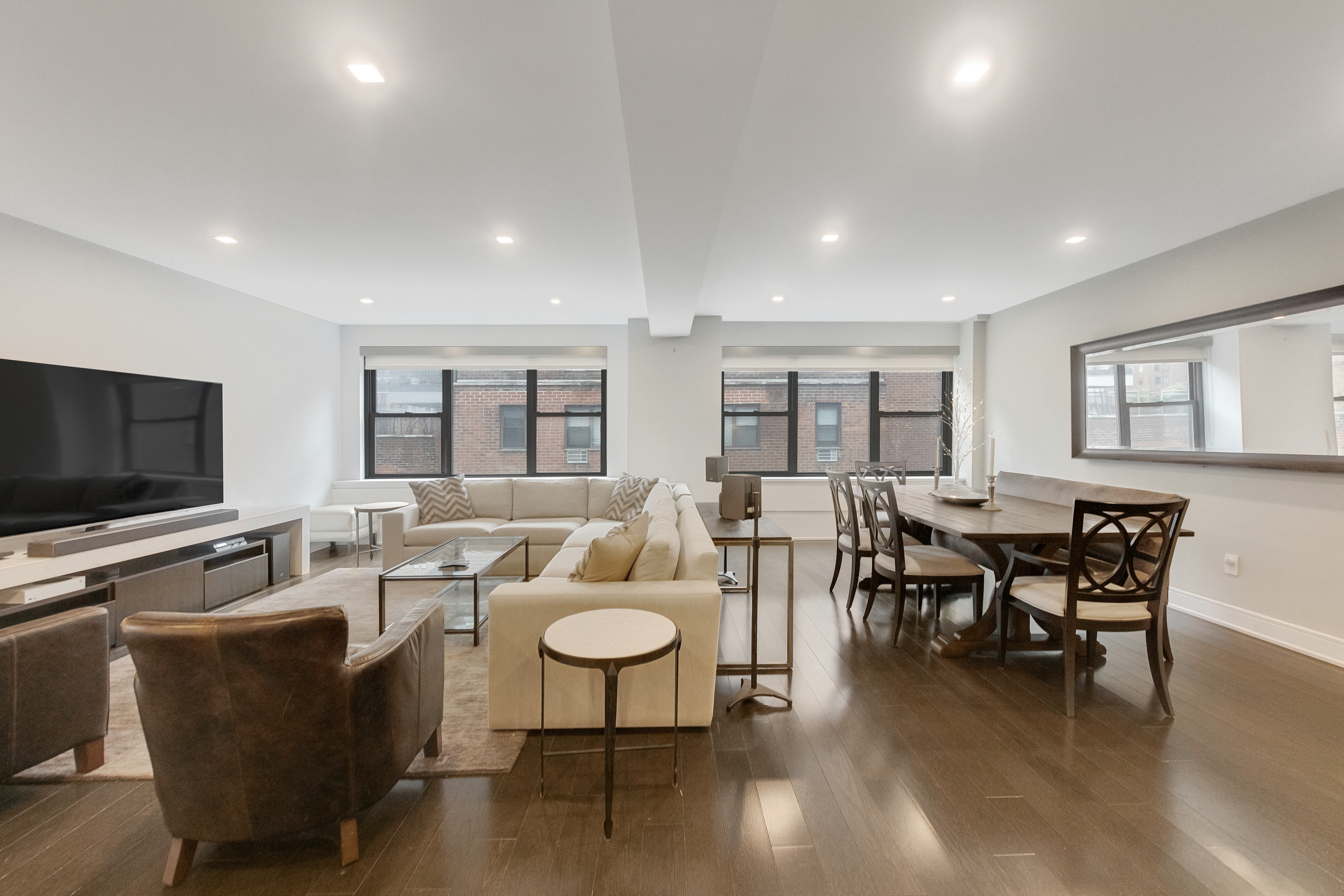 2 Tudor City Place, Unit 12DS Manhattan, NY 10017 - Photo 1 of 20 a living room with furniture and a flat screen tv