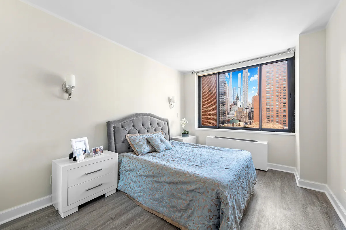300 East 62nd Street, Unit 1001 Manhattan, NY 10065 - Photo 4 of 10 a spacious bedroom with a bed and a window