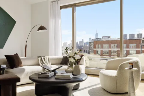 a living room with furniture and floor to ceiling windows